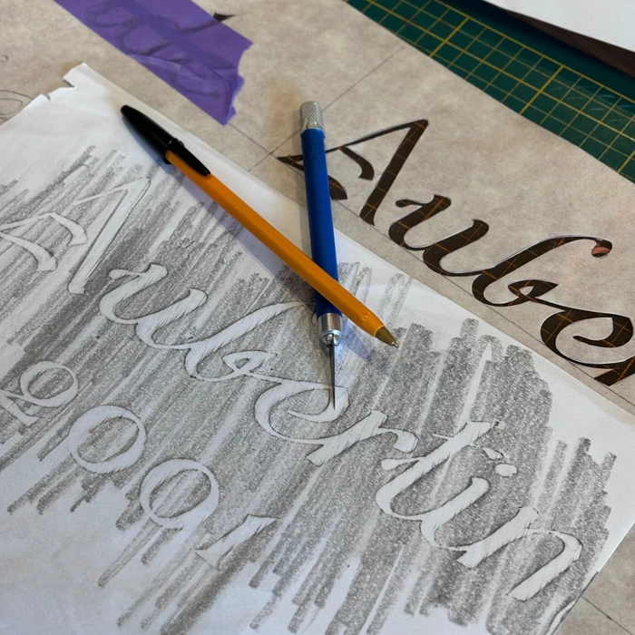 Laser cutting machine carving patterns on the plastic plate